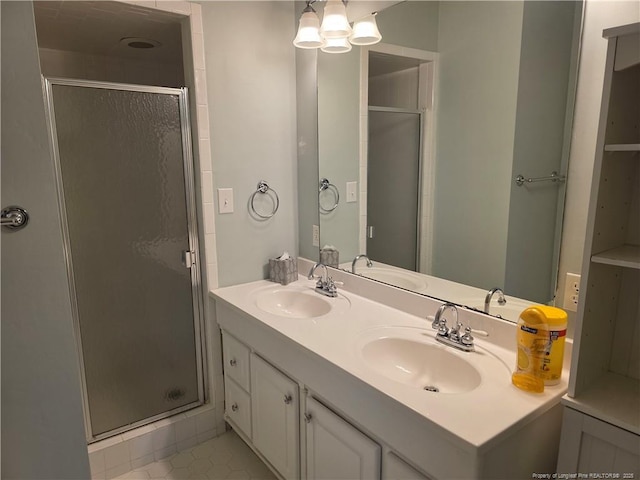 bathroom with a stall shower and a sink