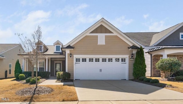 view of front of house with board and batten siding, an attached garage, and driveway