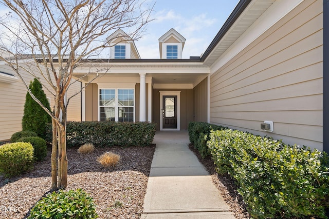 view of exterior entry featuring a porch