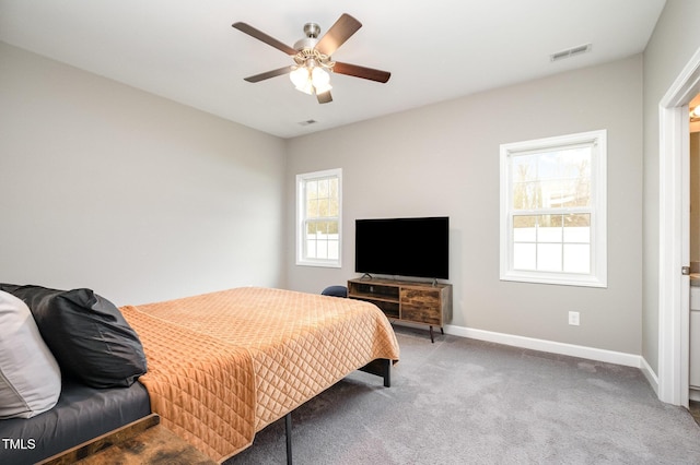 carpeted bedroom with visible vents, baseboards, and ceiling fan