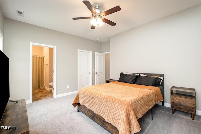 bedroom featuring visible vents, connected bathroom, baseboards, carpet flooring, and a ceiling fan