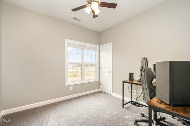 carpeted office featuring visible vents, ceiling fan, and baseboards