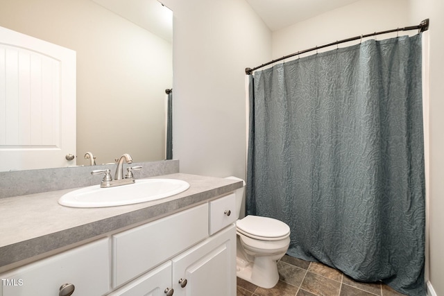 bathroom with toilet, vanity, and a shower with curtain