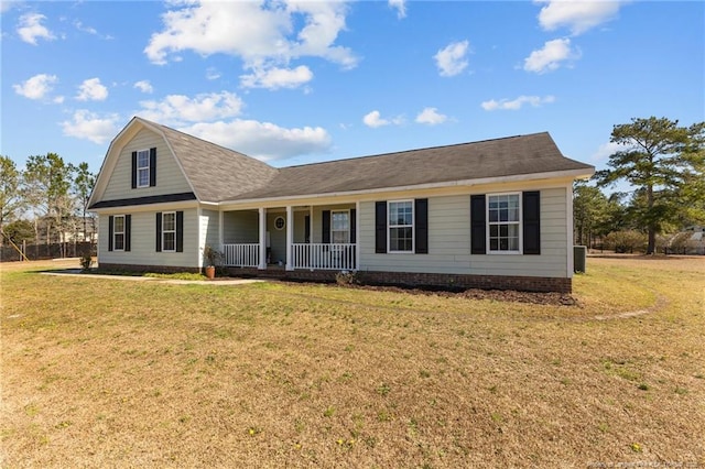 view of front of property with a front lawn, cooling unit, and covered porch