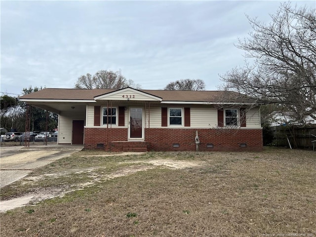 view of front facade featuring brick siding, crawl space, an attached carport, and driveway