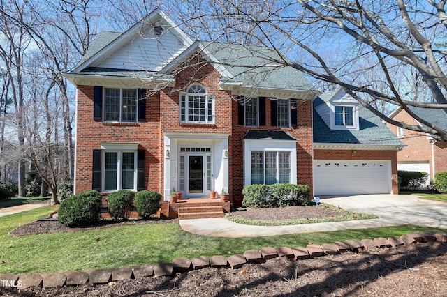 511 Windstream Way, Cary, NC 27518 - colonial inspired home with brick siding, a garage, driveway, a shingled roof, and a front yard
