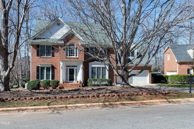 511 Windstream Way, Cary, NC 27518 - view of front of house featuring brick siding, concrete driveway, and a garage