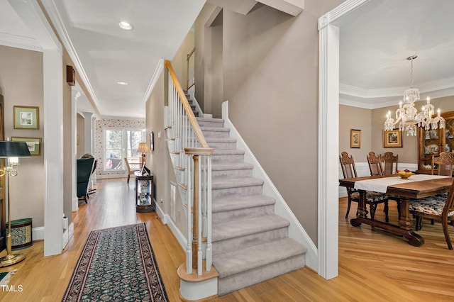 511 Windstream Way, Cary, NC 27518 - staircase featuring ornamental molding, wood finished floors, a chandelier, and baseboards