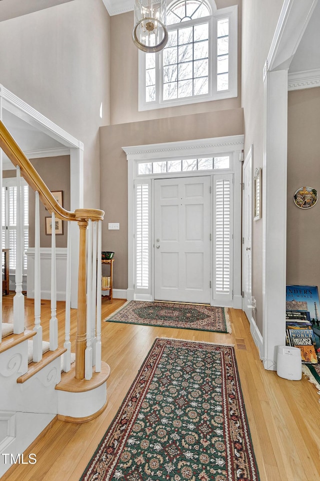 511 Windstream Way, Cary, NC 27518 - entryway featuring a high ceiling, wood finished floors, a chandelier, plenty of natural light, and baseboards