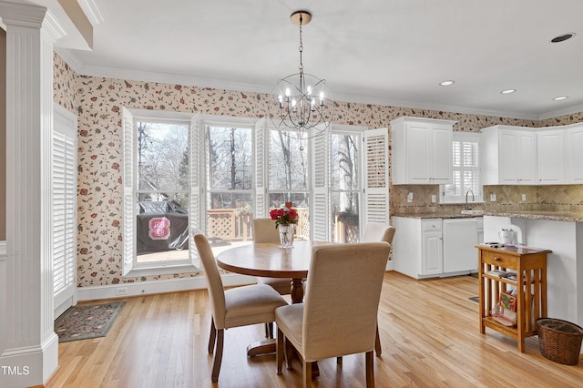 511 Windstream Way, Cary, NC 27518 - dining space featuring ornamental molding, a chandelier, light wood finished floors, wallpapered walls, and baseboards