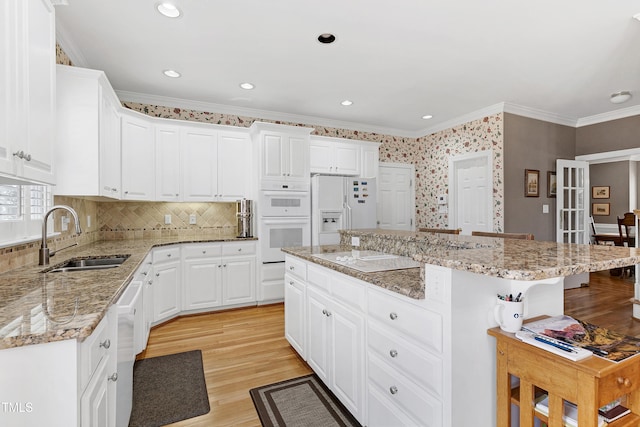 511 Windstream Way, Cary, NC 27518 - kitchen with a sink, a breakfast bar, white appliances, a kitchen island, and crown molding