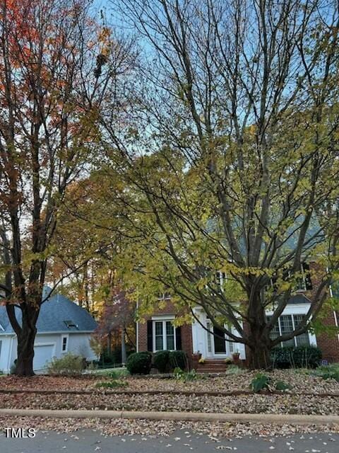 511 Windstream Way, Cary, NC 27518 - view of property hidden behind natural elements featuring brick siding