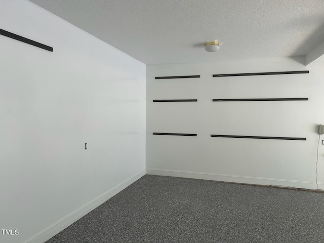 511 Windstream Way, Cary, NC 27518 - empty room featuring baseboards, a textured ceiling, and dark carpet