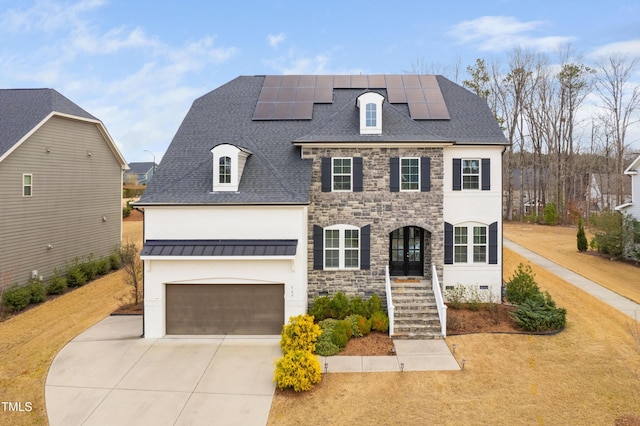 view of front of house with metal roof, stone siding, roof with shingles, and driveway