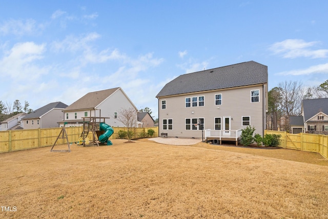 back of property featuring a playground, a residential view, a yard, a fenced backyard, and a patio area