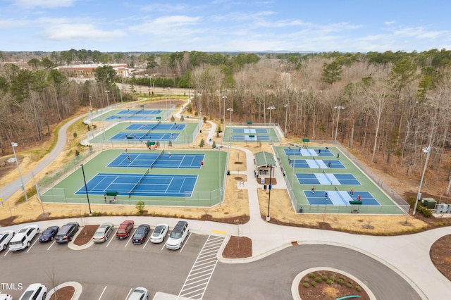 bird's eye view with a wooded view