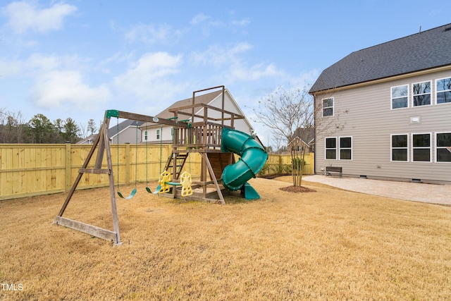 view of play area featuring a patio area, a yard, and fence