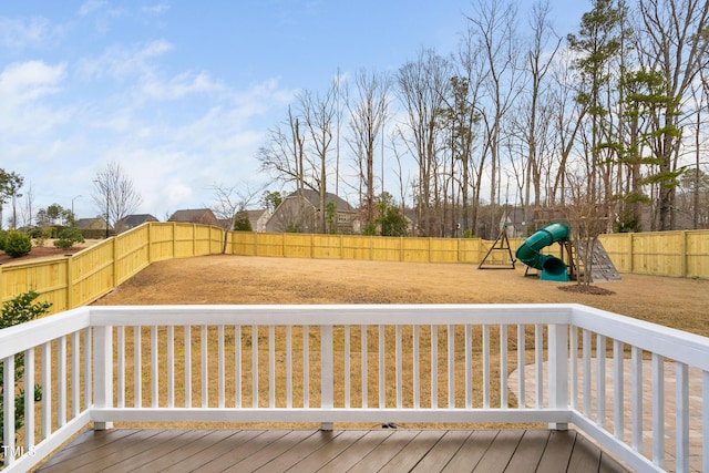 deck with a playground and a fenced backyard