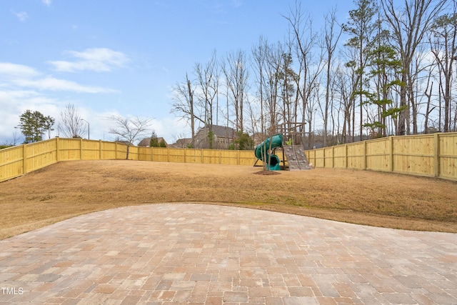 exterior space featuring a patio area, a fenced backyard, and a playground