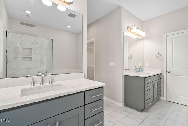 full bath with visible vents, marble finish floor, a shower stall, and a sink