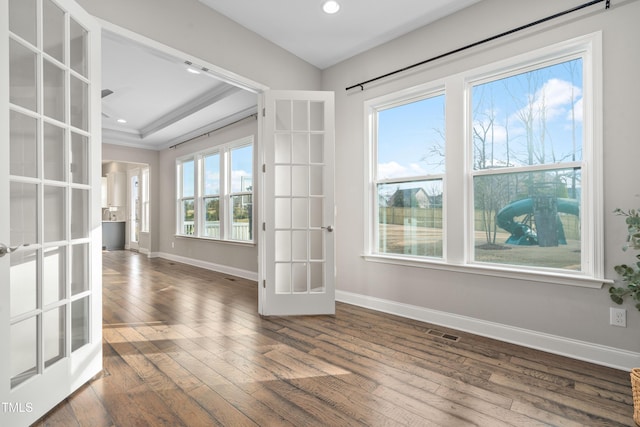 unfurnished room featuring visible vents, baseboards, ornamental molding, hardwood / wood-style flooring, and french doors