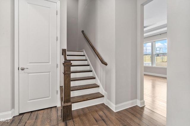 stairway featuring hardwood / wood-style floors and baseboards