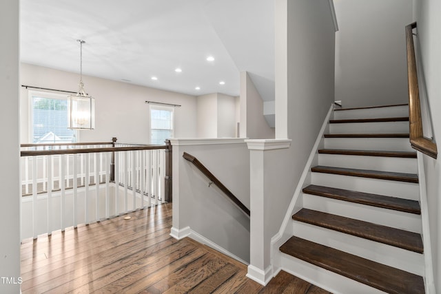 stairway featuring recessed lighting, wood finished floors, and baseboards