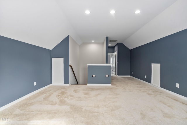 additional living space featuring visible vents, baseboards, vaulted ceiling, carpet floors, and recessed lighting