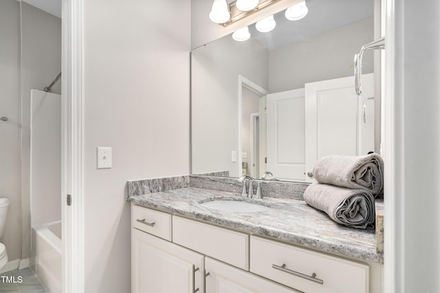 bathroom with toilet, vanity, and washtub / shower combination