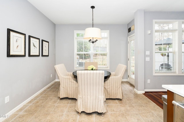 dining space with light tile patterned floors and baseboards