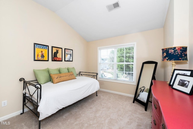 bedroom featuring lofted ceiling, baseboards, visible vents, and light carpet