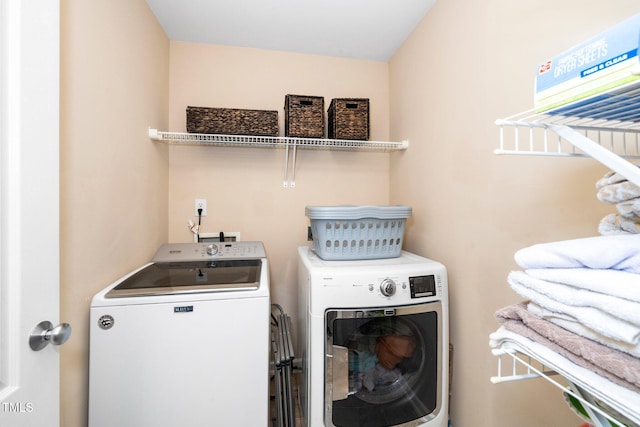 clothes washing area with laundry area and independent washer and dryer