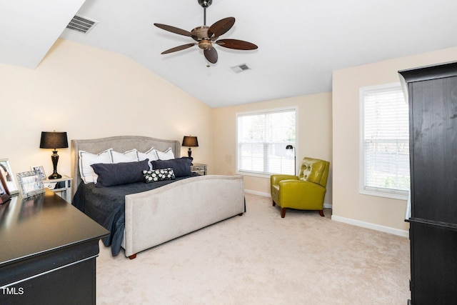 bedroom with visible vents, lofted ceiling, light colored carpet, and baseboards