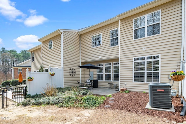 back of property featuring a patio area, central air condition unit, and fence