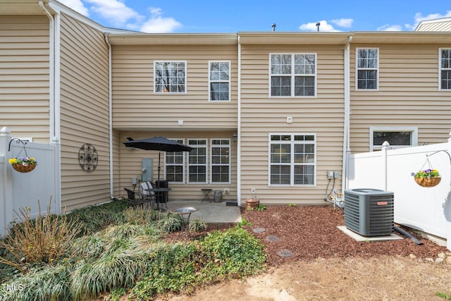 back of property featuring a patio, central AC unit, and fence