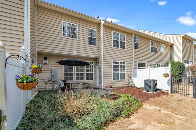 rear view of house featuring central air condition unit, a patio, and fence