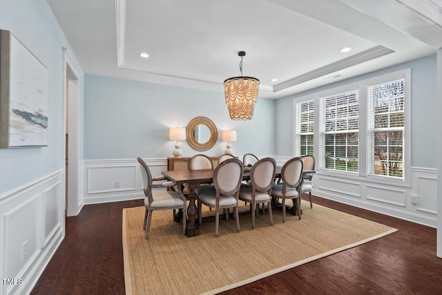 dining space featuring a raised ceiling, recessed lighting, and dark wood-type flooring