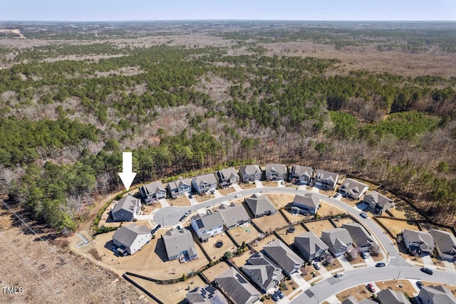 bird's eye view with a residential view and a wooded view