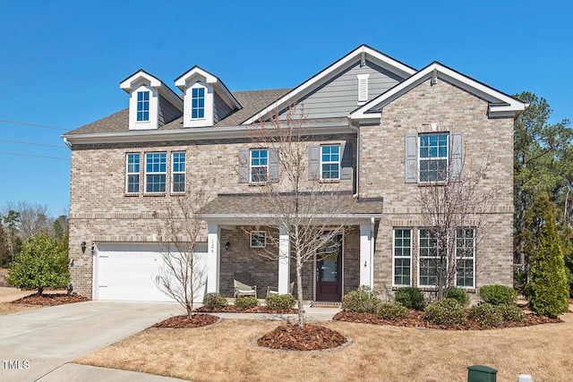 view of front of house with concrete driveway, an attached garage, and brick siding