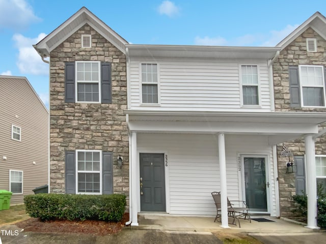 view of front of house featuring covered porch and stone siding