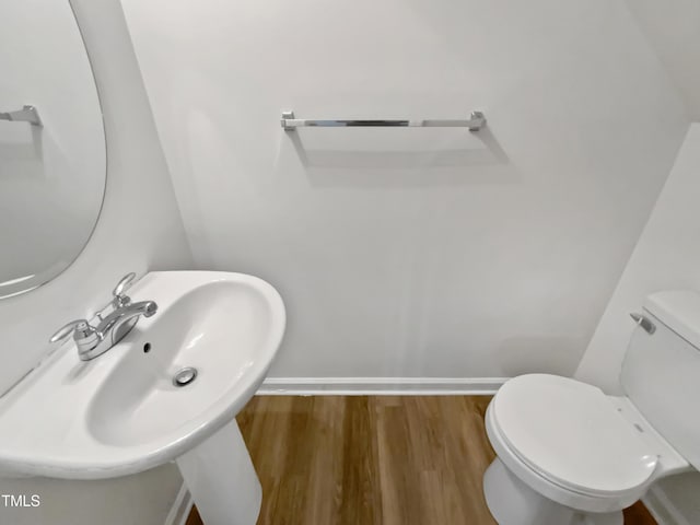 2356 Bay Harbor Dr, Raleigh, NC 27604 - half bath featuring a sink, baseboards, toilet, and wood finished floors