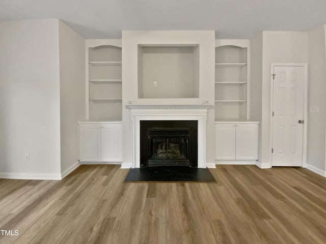 2356 Bay Harbor Dr, Raleigh, NC 27604 - unfurnished living room featuring baseboards, wood finished floors, and a fireplace
