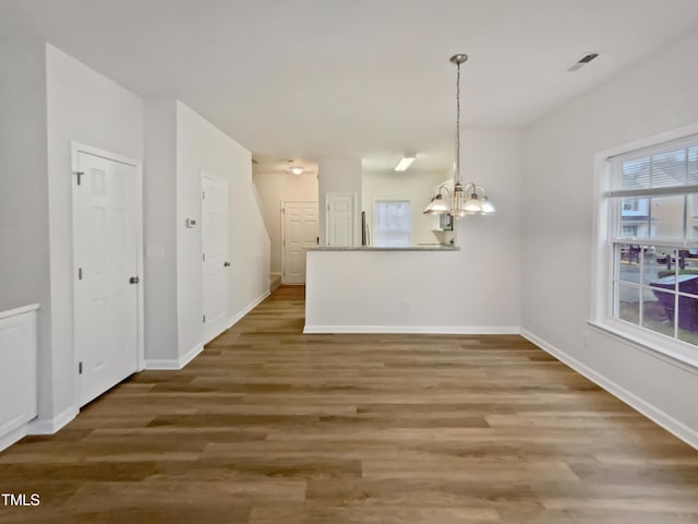 2356 Bay Harbor Dr, Raleigh, NC 27604 - unfurnished dining area with a chandelier, visible vents, baseboards, and wood finished floors