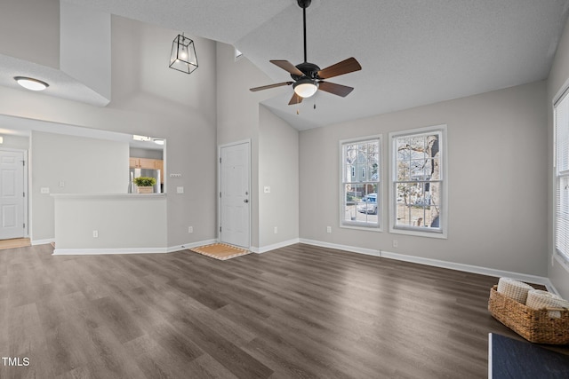 unfurnished living room with dark wood-style floors, a textured ceiling, and baseboards