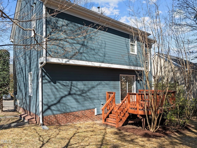 rear view of house featuring a wooden deck