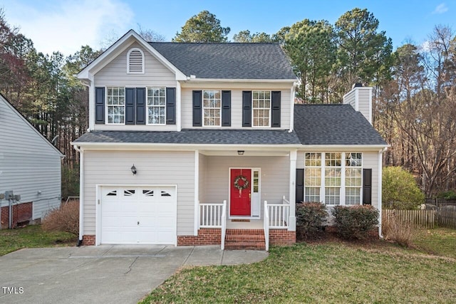 traditional-style home with driveway, a front lawn, roof with shingles, an attached garage, and a chimney