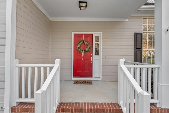 view of exterior entry with a porch