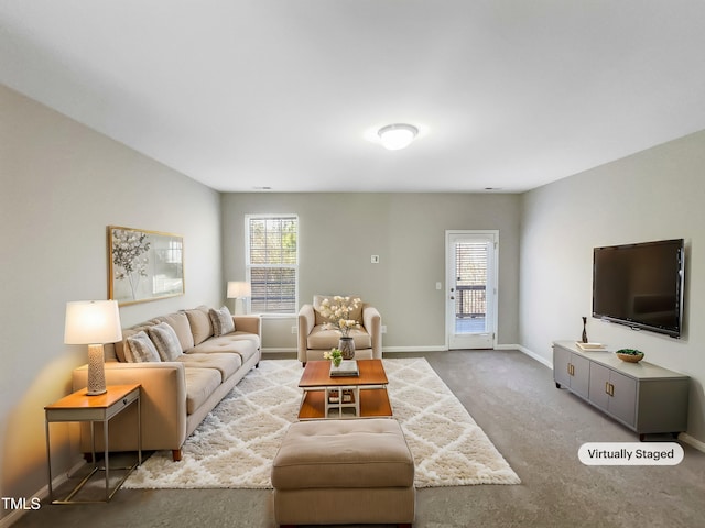 carpeted living room featuring baseboards