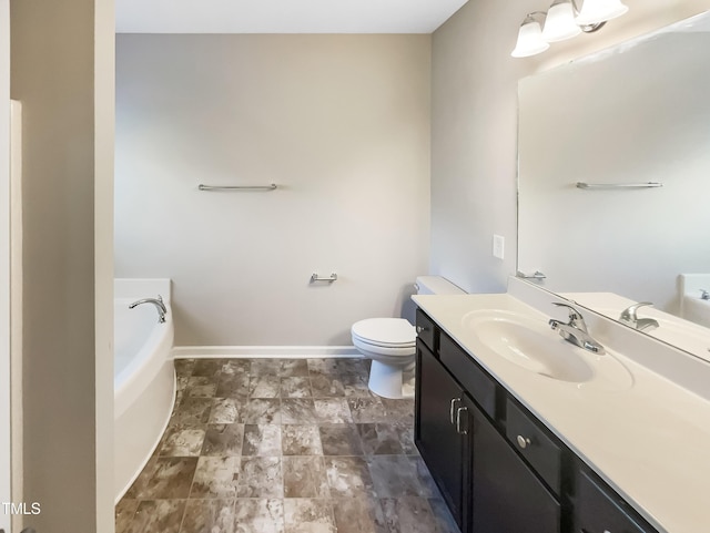 bathroom featuring vanity, a garden tub, toilet, and baseboards