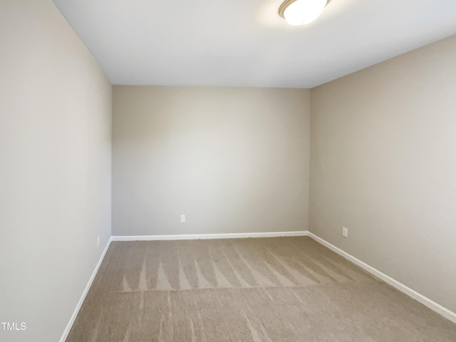 carpeted empty room with baseboards